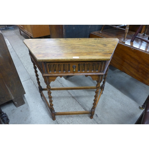 150 - A 17th Century style oak single drawer barleytwist credence table