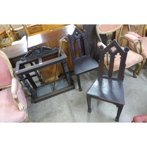 159 - A Victorian Jacobean Revival carved oak stickstand and a pair of Victorian Gothic Revival oak hall c... 