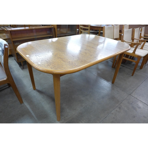 21 - A Danish teak extending dining table