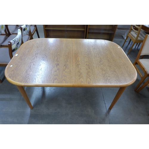 21 - A Danish teak extending dining table