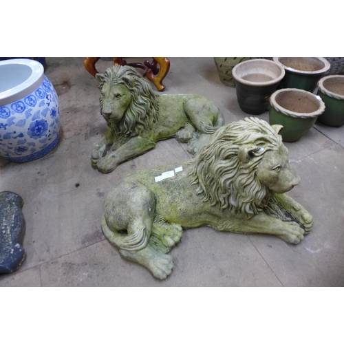 280 - A pair of concrete garden figures of recumbent lions