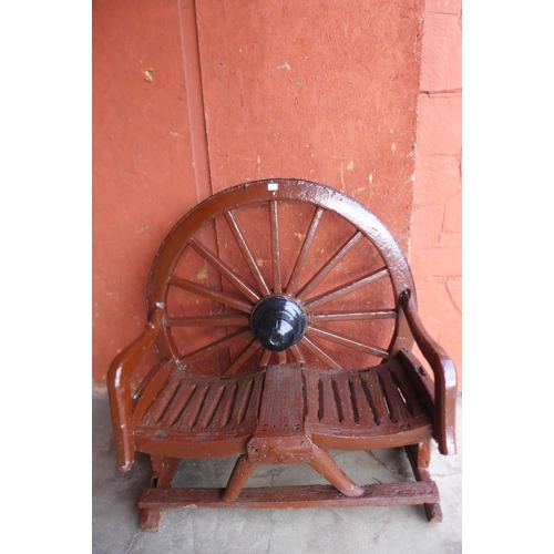 291A - A wooden cartwheel garden bench