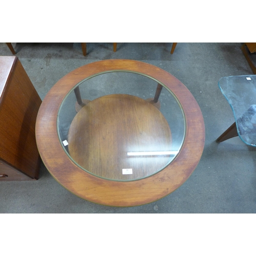 33 - A circular teak and and glass topped coffee table