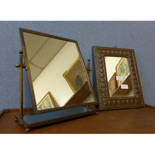 332 - An embossed copper framed mirror and a brass shaving mirror