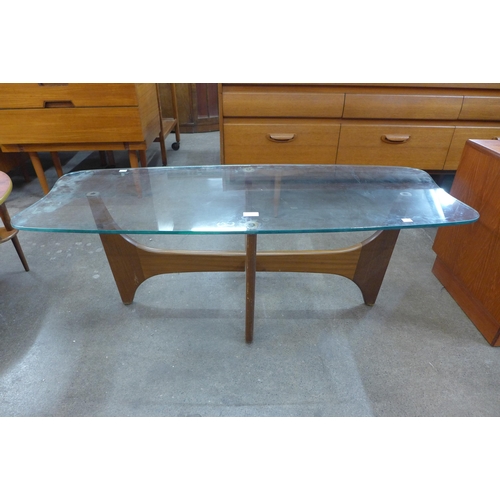 34 - A teak and glass topped coffee table