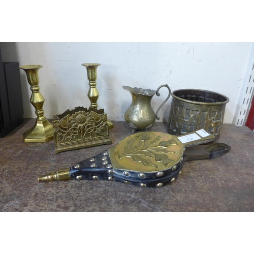 353 - A pair of small brass candlesticks, a leather rack, fire bellows, etc.