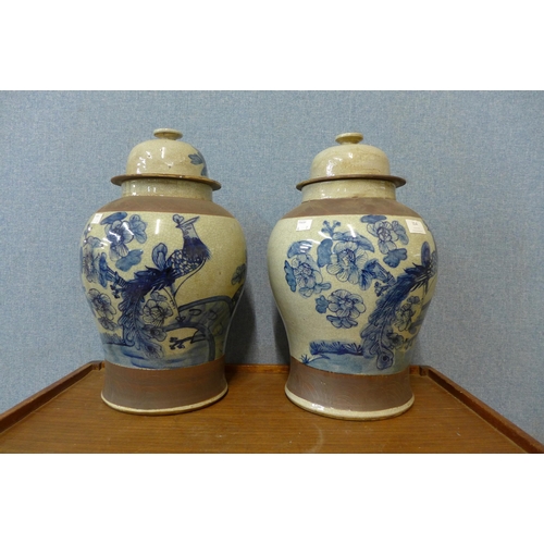 354 - A pair of oriental blue and white stoneware ginger jars and covers