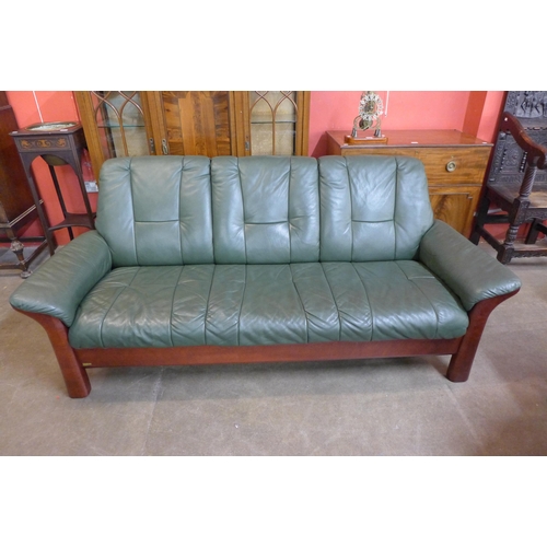 45 - A Norwegian Ekornes beech and green leather Stressless five piece suite, comprising; settee, two arm... 