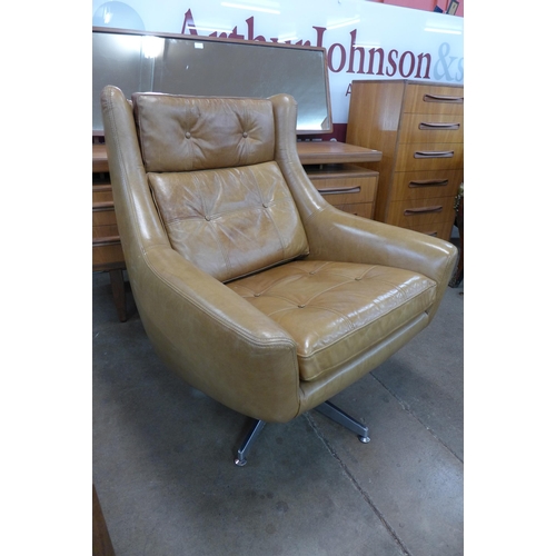 6 - A chrome and tan leather revolving armchair