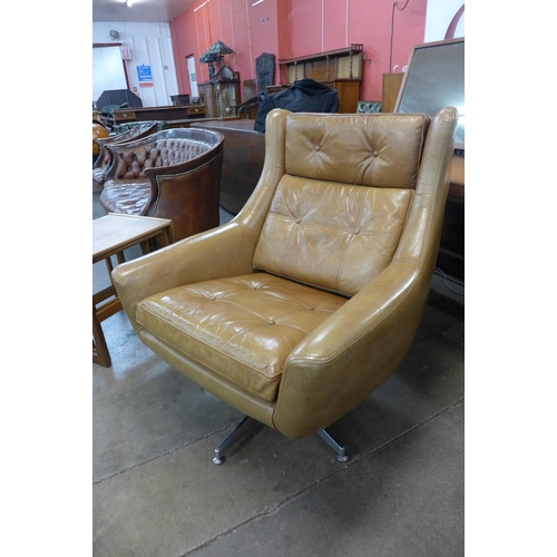 6 - A chrome and tan leather revolving armchair