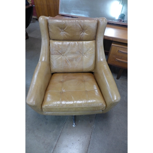 6 - A chrome and tan leather revolving armchair