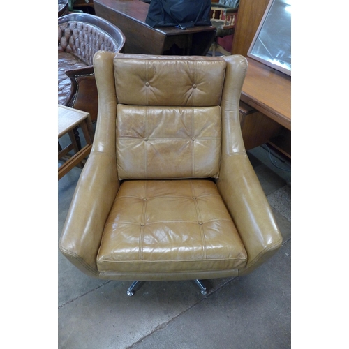 6 - A chrome and tan leather revolving armchair