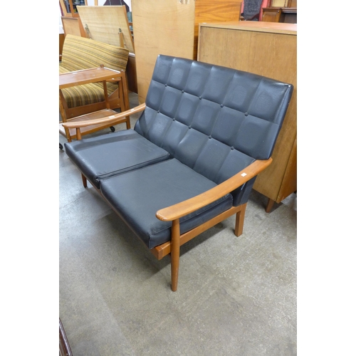 64 - A teak and black vinyl settee