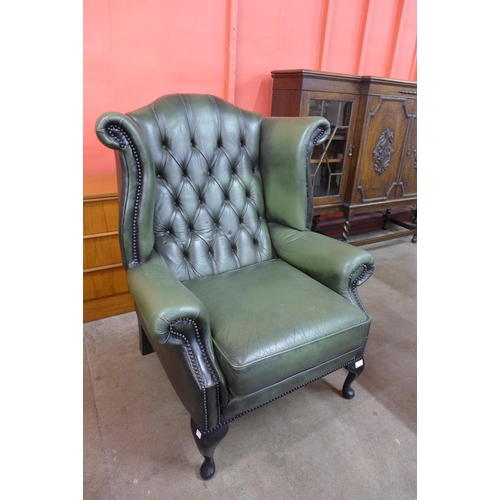 93 - A Chesterfield green leather wingback armchair