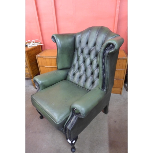 93 - A Chesterfield green leather wingback armchair