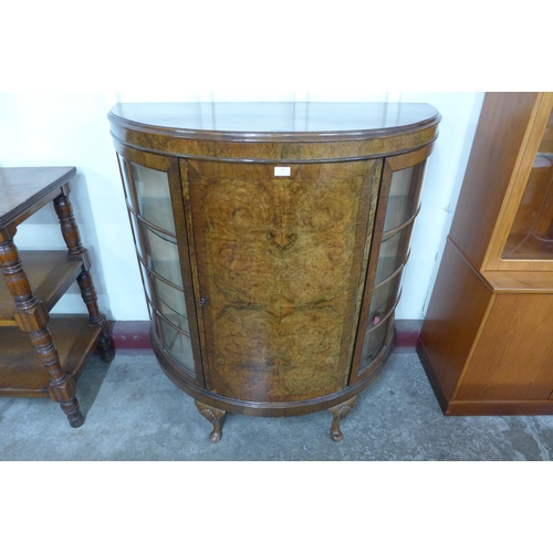 96 - An early 20th Century burr walnut demi lune side cabinet