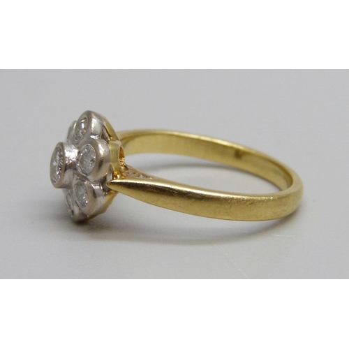 1023 - An 18ct gold and diamond daisy cluster ring, 3.3g, K