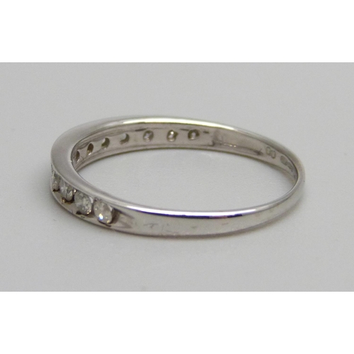 1051 - A 9ct white gold and diamond half eternity ring with twelve diamonds, 0.25ct diamond weight, 1.2g, L