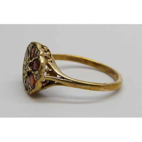 1066 - A 9ct gold, garnet and diamond cluster ring, 2.8g, S