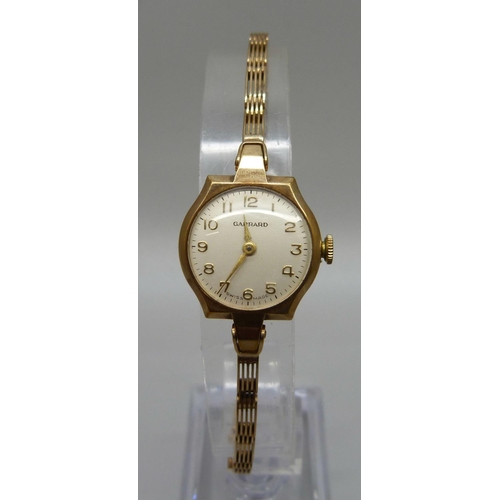 1069 - A lady's 9ct gold Garrard wristwatch on a 9ct gold bracelet strap, the case back bears inscription, ... 