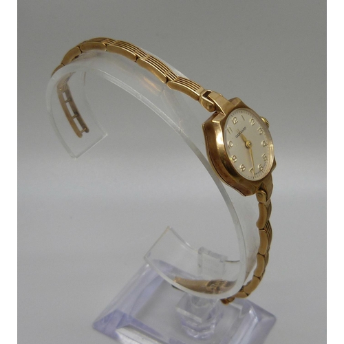 1069 - A lady's 9ct gold Garrard wristwatch on a 9ct gold bracelet strap, the case back bears inscription, ... 