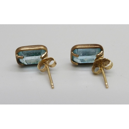 1100 - A pair of 9ct gold and blue topaz earrings, 2.6g