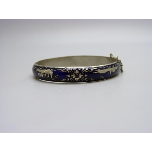 1107 - A white metal and blue enamelled bangle