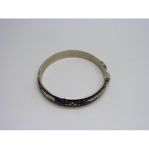 1107 - A white metal and blue enamelled bangle