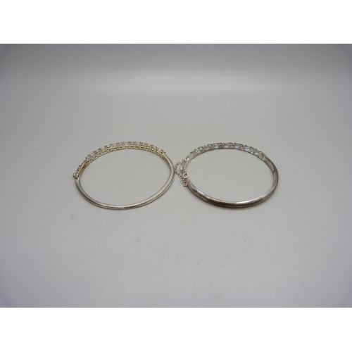 1131 - A silver and topaz bangle and a silver and white stone bangle