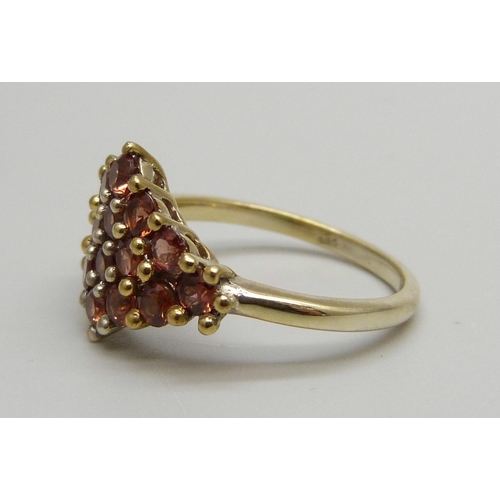 1144 - A silver gilt and pink garnet cluster ring, S