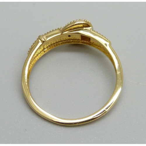 1147 - A silver gilt buckle ring with diamond accent, R