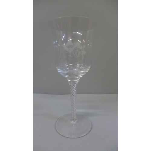 608 - A Masonic glass wine goblet with applied symbols and Courage and Prudence in Latin, monogram to base