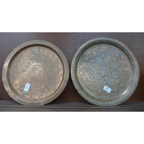 616 - Two Persian copper chargers, one signed on the back in Arabic, largest 34cm