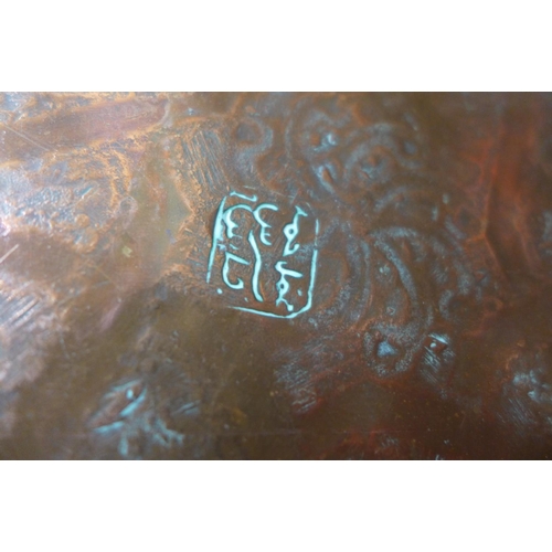 616 - Two Persian copper chargers, one signed on the back in Arabic, largest 34cm