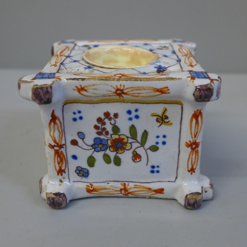 631 - A late Victorian faience inkwell with floral decoration, 63mm tall