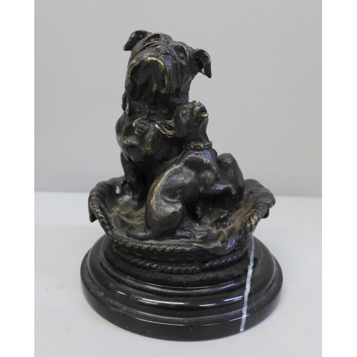 676 - A bronze model of two dogs in a basket, after Giuseppe Onway