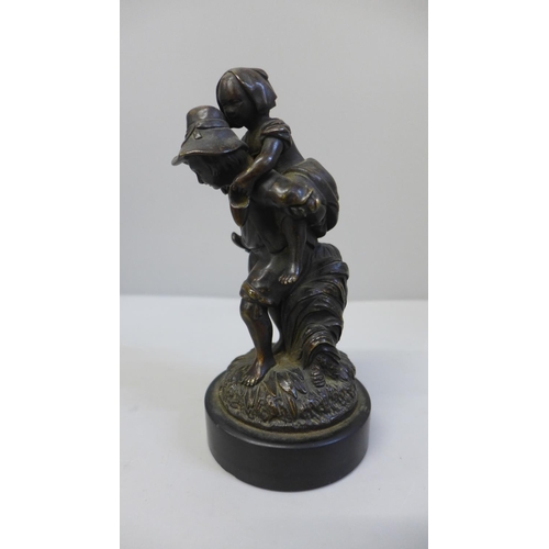 677 - A Dutch bronze figure group of a boy giving a piggy-back to a young girl, 15cm