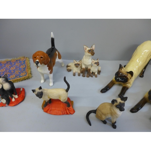 698 - A collection of cat figures and a Beswick dog