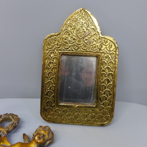 774 - Three mirrors, brass fronted, gilt example depicting cherubs and one other