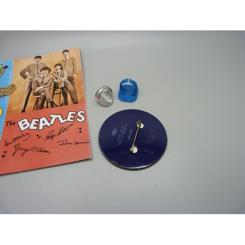 864 - The Beatles jewellery; necklace on card, flasher badge and two flasher rings