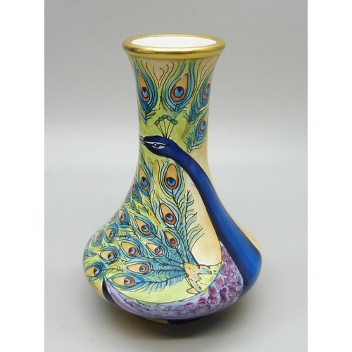 880 - A Moorcroft peacock pattern enamel miniature vase