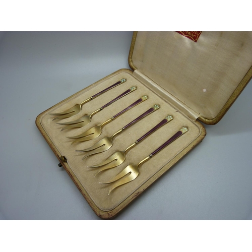 896 - A cased set of six silver gilt and enamel pickle forks, import mark