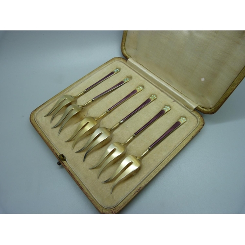 896 - A cased set of six silver gilt and enamel pickle forks, import mark