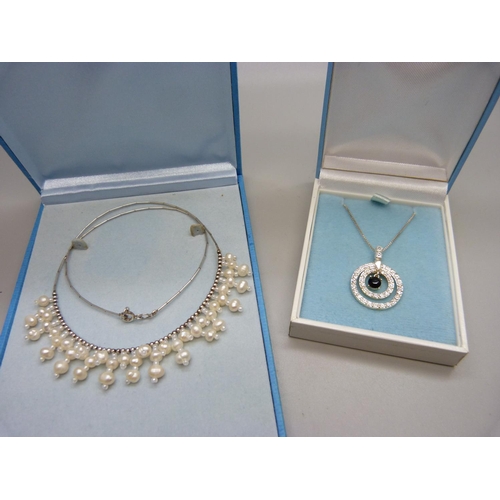 904 - Two boxed 925 silver necklaces, one with freshwater pearls and bead adornment