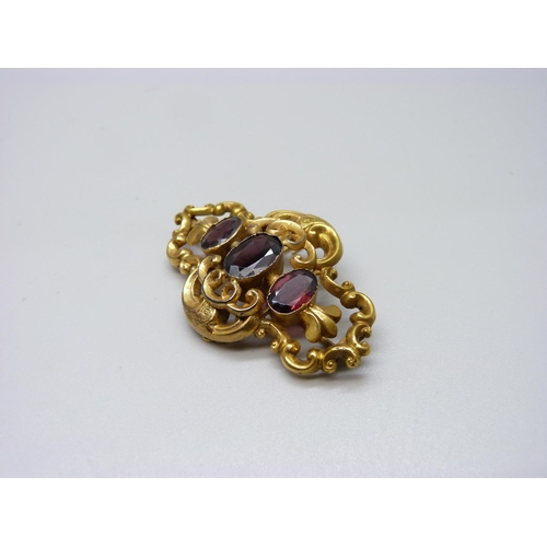 964 - A yellow metal and stone set brooch, stones test as amethyst, 16g, 55mm