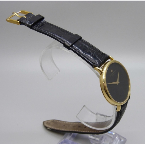 965 - An 18ct gold Vacheron & Constantin Geneve dress wristwatch, the 33mm case marked 520950, on a black ... 