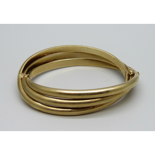 993 - A 9ct gold bangle with hinge, 26.7g, 52mm x 58mm