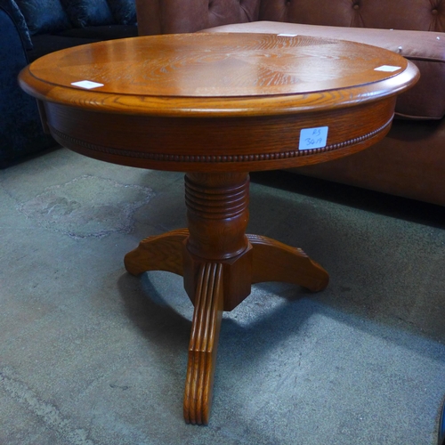 1602 - A circular wooden engraved lamp table