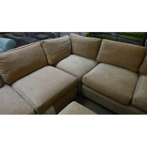 1606 - A sand upholstered corner sofa and footstool