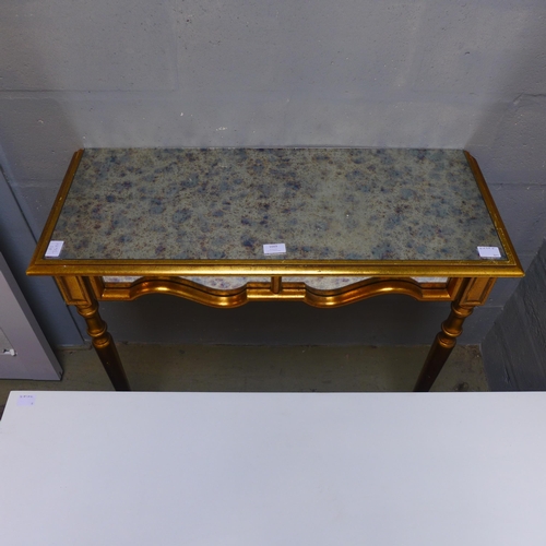 1669 - An opaque glass and gold effect wall mounted console table